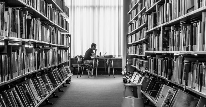 person sitting in a library.