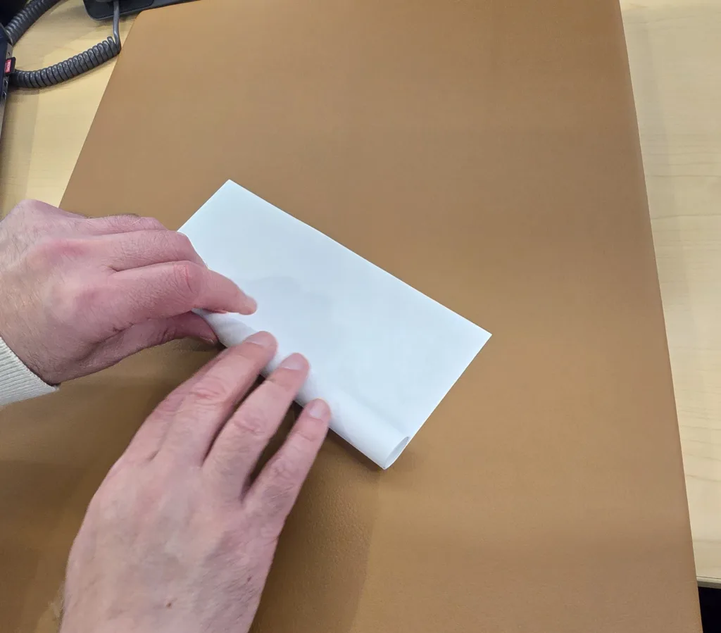 keep rolling paper until you form a tube.