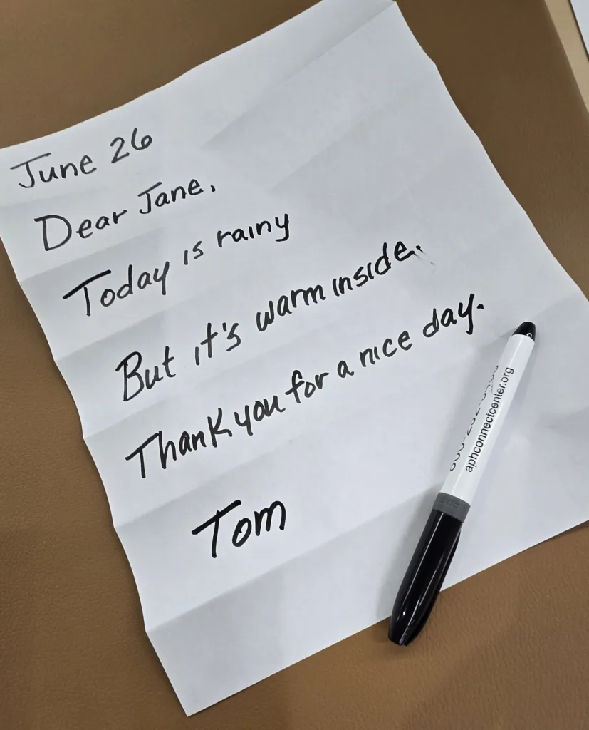 Paper is unfolded showing a completed letter. 