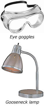 this is an image of eye goggles and a gooseneck lamp