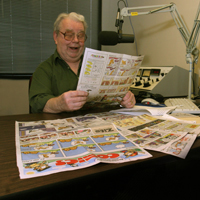 Volunteer reads the comics section of the newspaper for a radio reading service