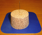 Stick your needle into a cork or piece of soap