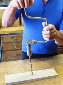 Brace and bit drilling a hole