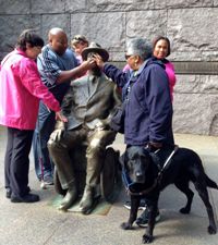 Empish and four other people around a bronze sculpture of Franklin D. Roosevelt