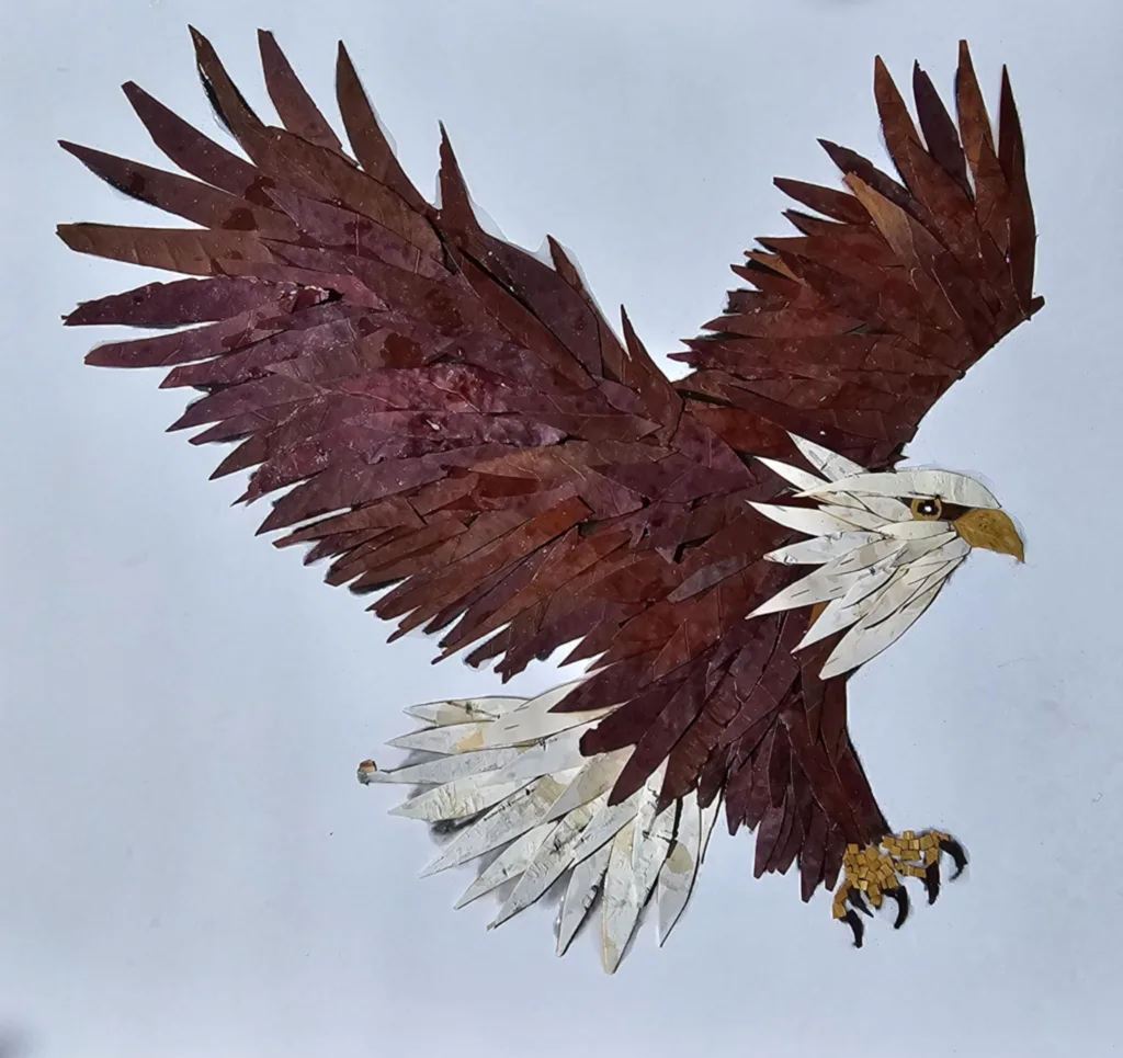 pointy wing shapes are cut from brown and white leaves to depict a bald eagle in flight 