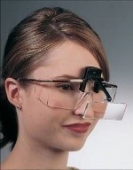 woman wearing a loupe for reading