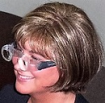 woman wearing spectacle-mounted telescopes