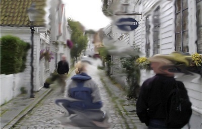simulated vision: people walking on narrow road between buildings; portions of the image are distorted with a blurred effect