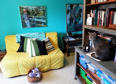 Lynda’s “knitting nook” with a futon,
shelving, her knitting basket, and her cat