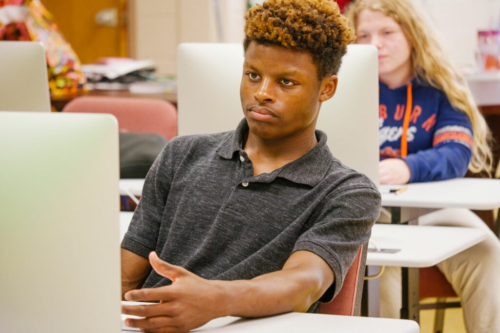 Young adult sitting at a computer