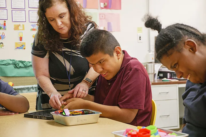 A teacher supporting a student learning