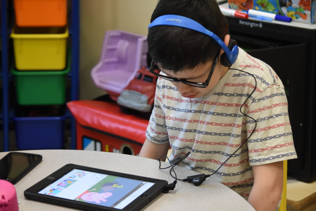 Student with iPad and headphones