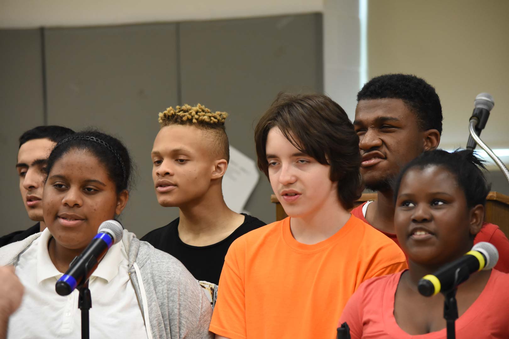 A group of middle school choir students singing.