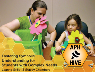 A teacher and a young girl are sitting at a table engaging in a symbolic learning activity using colorful flower props. The image has a yellow honeycomb design overlay with text that reads 'Fostering Symbolic Understanding for Students with Complex Needs' by Leanne Grillot & Stacey Chambers, and the APH Hive logo featuring a stylized beehive and bees