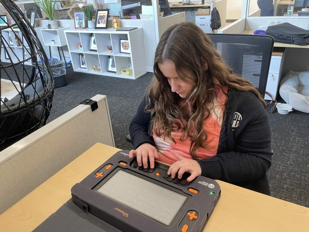 Person sitting at a desk using the Monarch