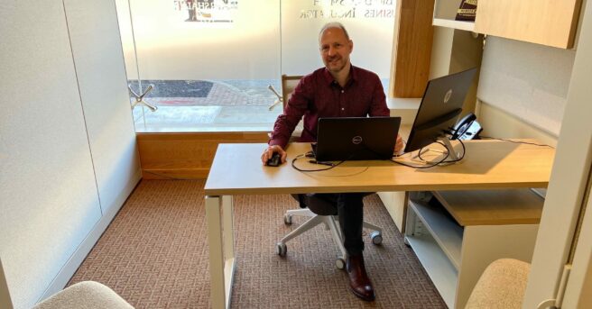 Lee Huffman sitting at his desk at APH Huntington