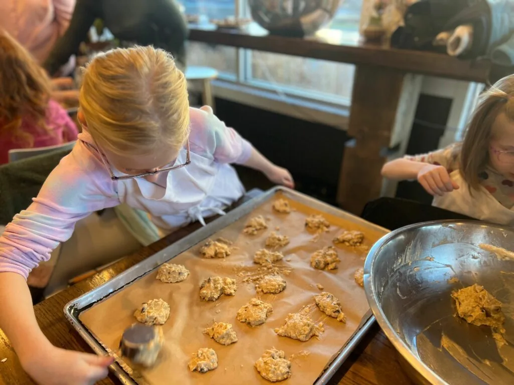 child scooping cookie dough