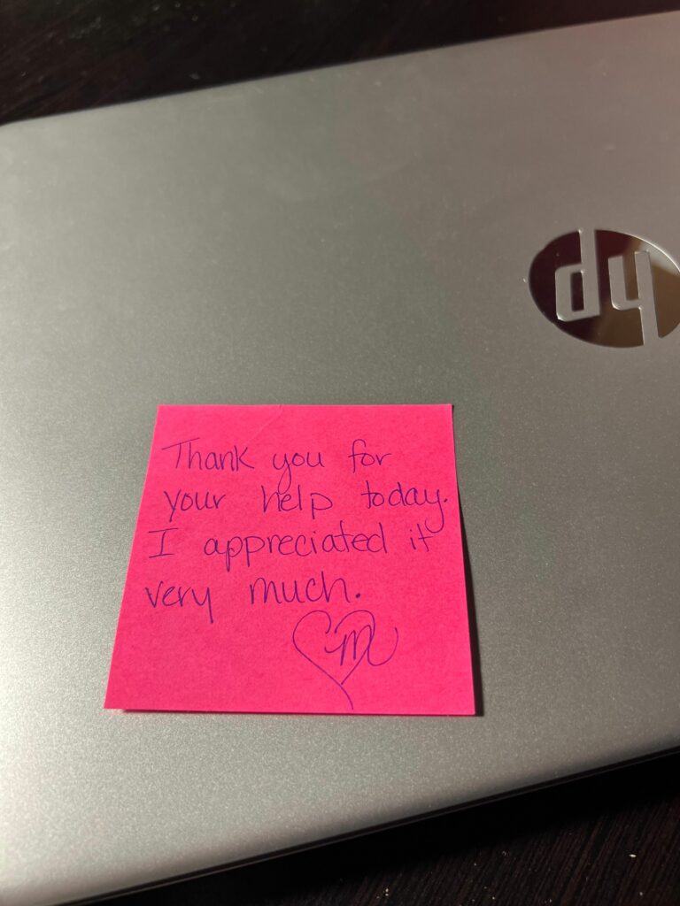Post-It note on laptop reads, “Thank you for your help today. I appreciated it very much. Heart, M.” 