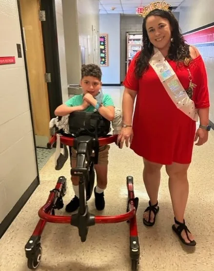 A teacher walking with a student. 