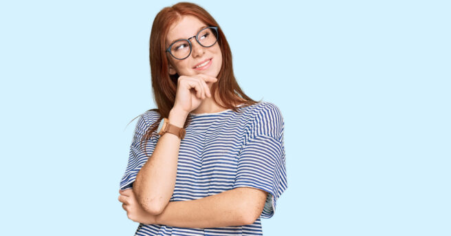 Teen wearing glasses appears to be deep in thought