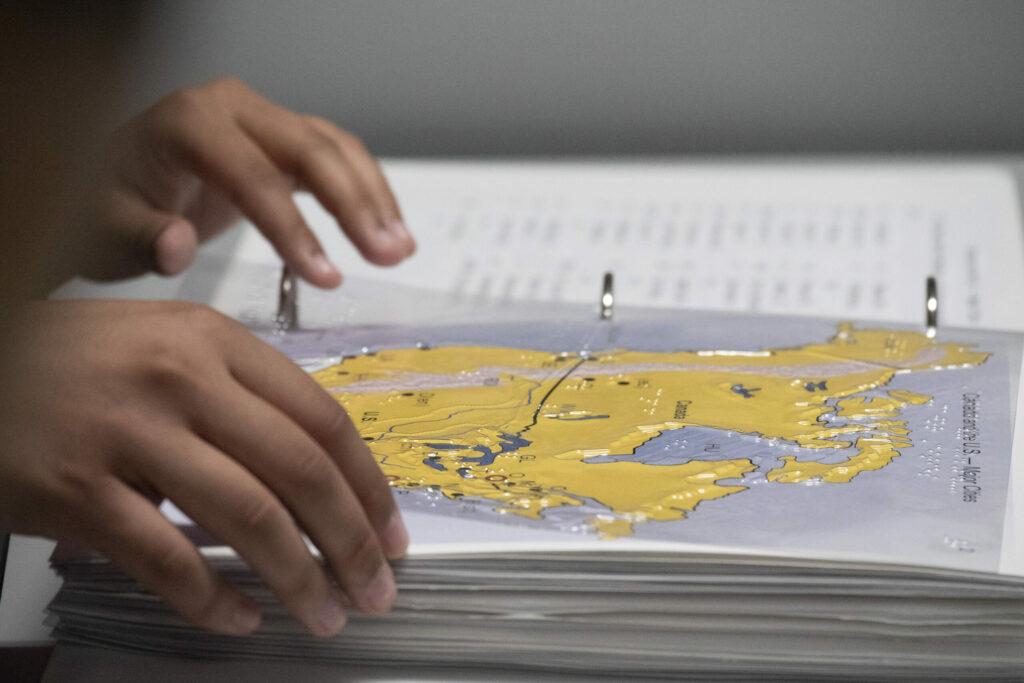 A student using a tactile map of the United States.