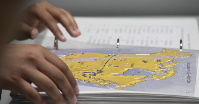 A student using a tactile map of the United States.