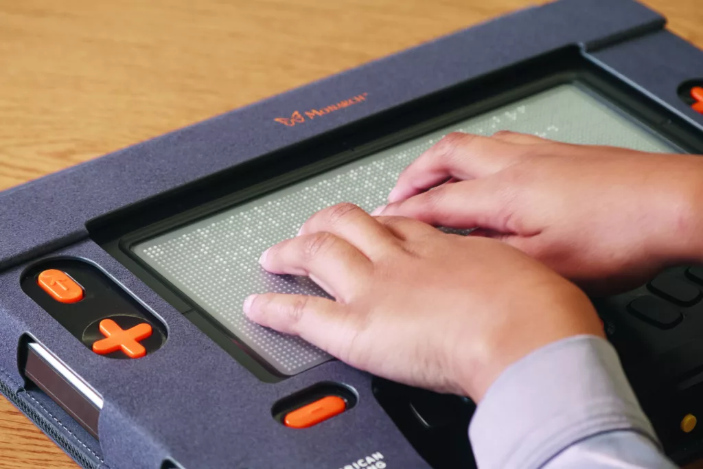 child using the Monarch, a 10-line refreshable braille display 