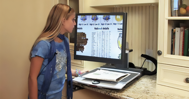 young woman looking at computer with screen magnification