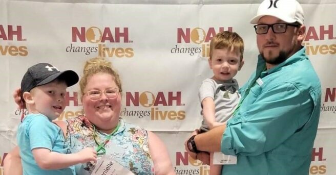 Family of four in front of a NOAH backdrop