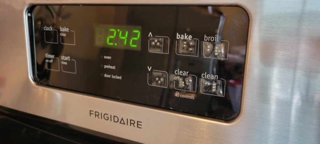 Display of an oven with braille labels added to buttons.