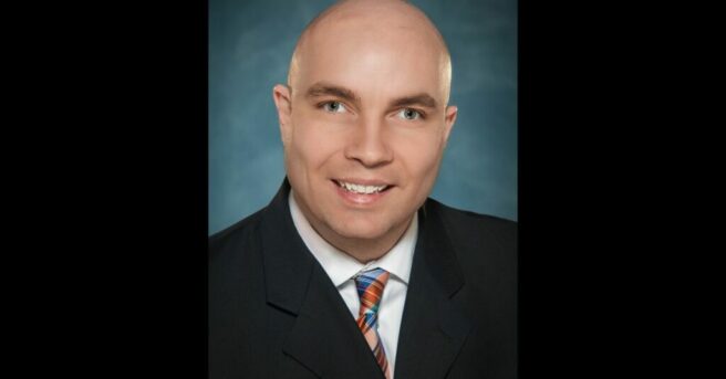 professional headshot of individual with light eyes wearing a suit