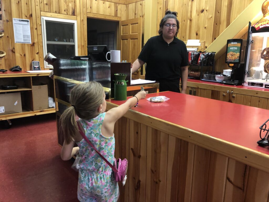 Small Child Handing Money Across the Counter