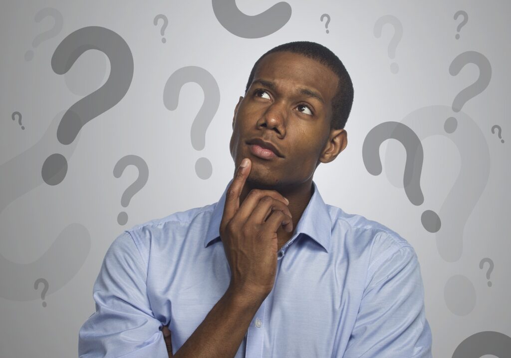 Individual with question marks swirling around their head