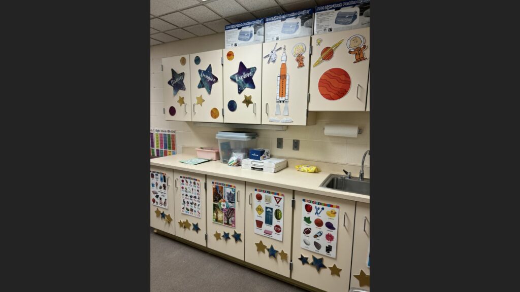 classroom cabinets decorated with space-themed pictures