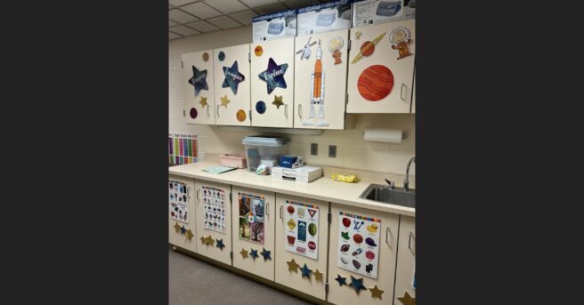 classroom cabinets decorated with space-themed pictures