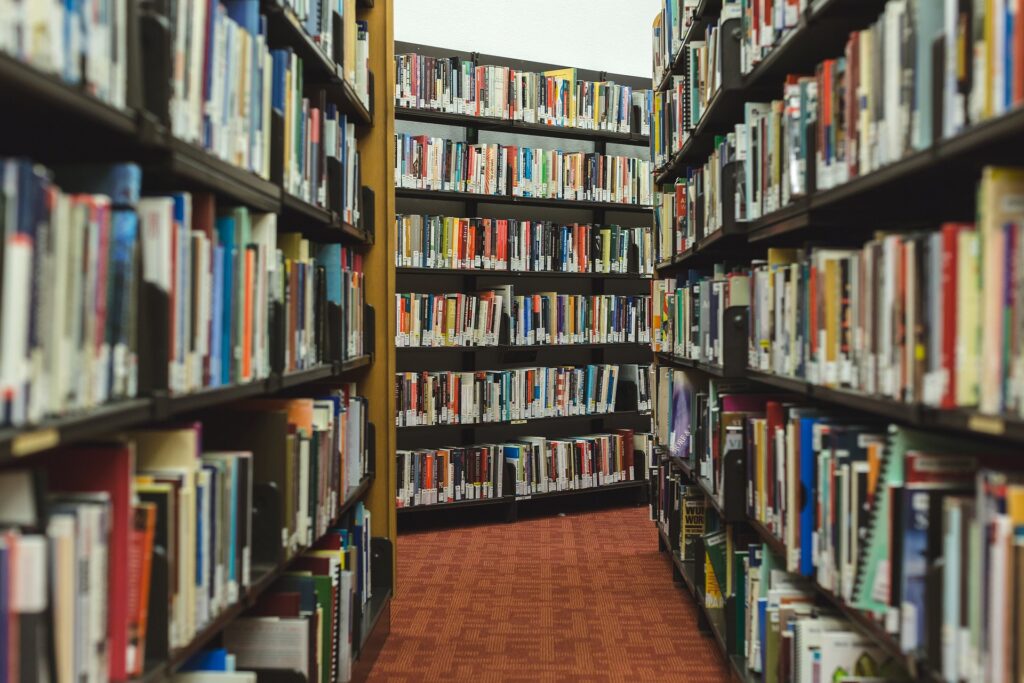 Photo of many books on shelves at a library