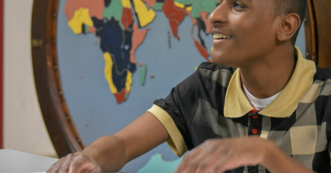 Individual exploring a tactile graphic with braille