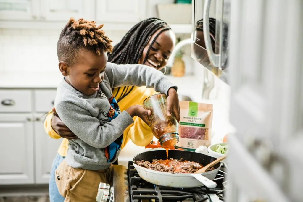 mother and son cooking at the stove