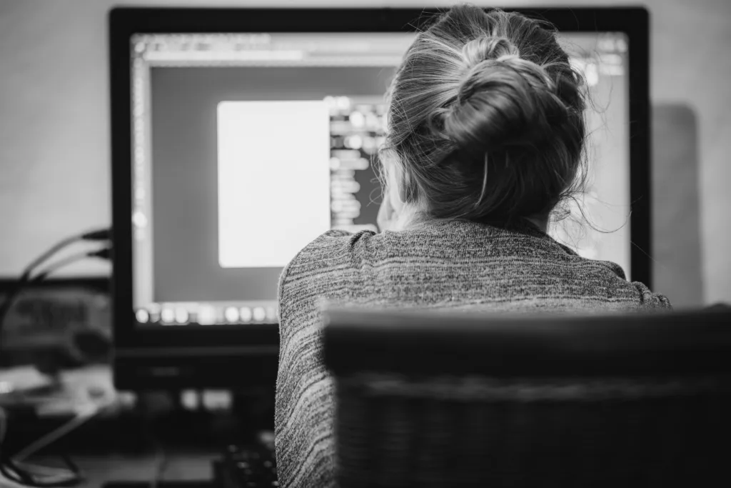 woman working in front of a computer screen