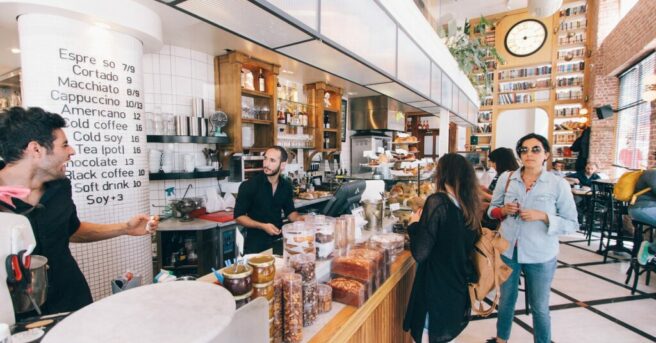 Barista coworkers making eye contact and laughing