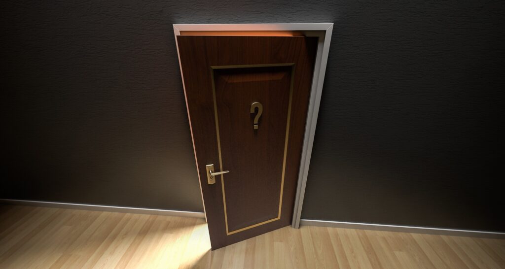 A cracked door with a question mark on it.