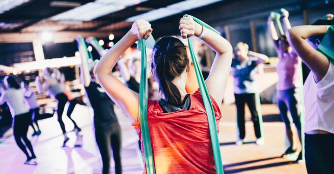 group fitness class using exercise bands