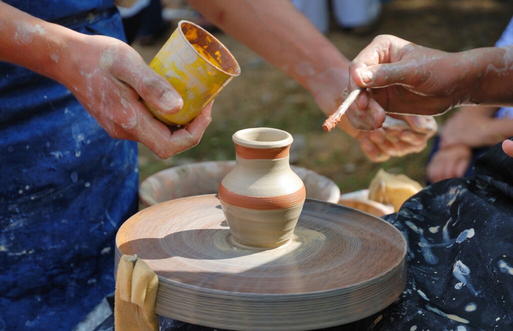 hands making a small ceramic vase