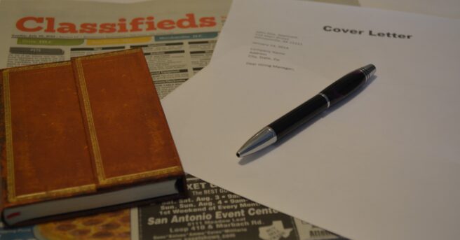 Photo of newspaper, notebook, pen and cover