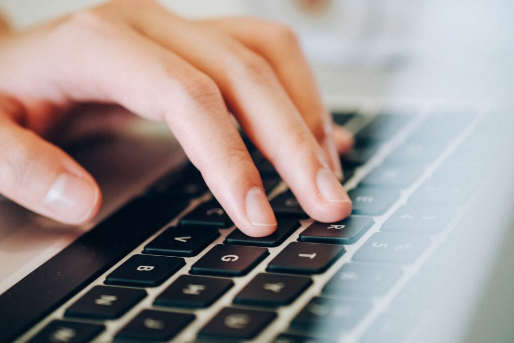 Fingers touching a computer keyboard