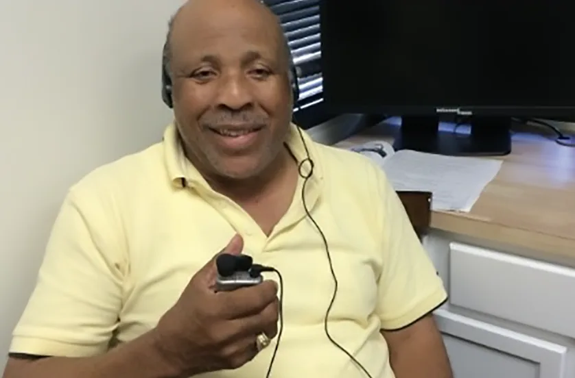 man using assistive listening device