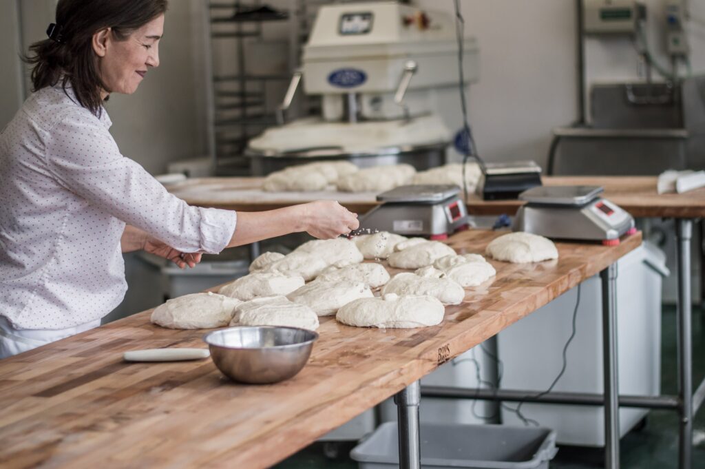 woman making dough in a bakery credit: Maranda Vandergriff @mkvandergriff