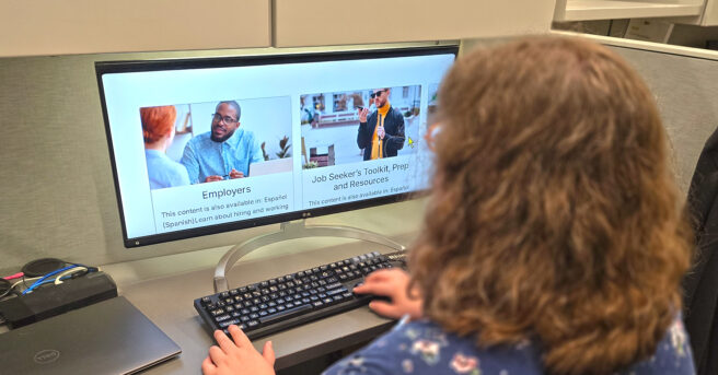 Person working at a desk with a magnified screen