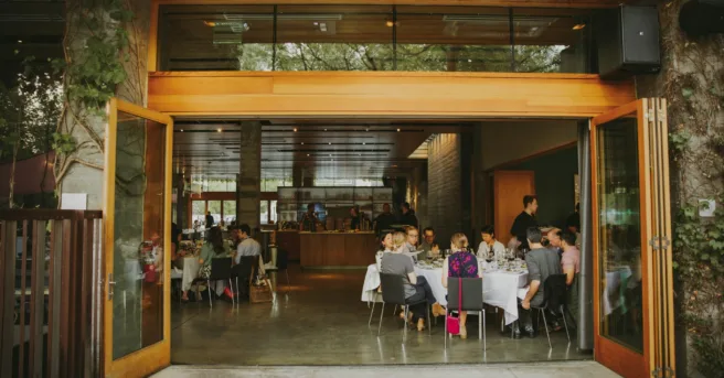 group of young professionals gather around a round table for a meal
