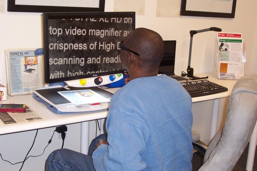 Man reading with video magnifier